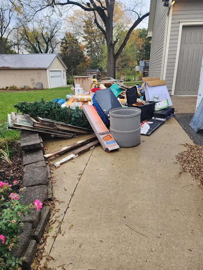Dumpster being loaded with debris for 12 Yard Dumpster Rental in Cheltenham